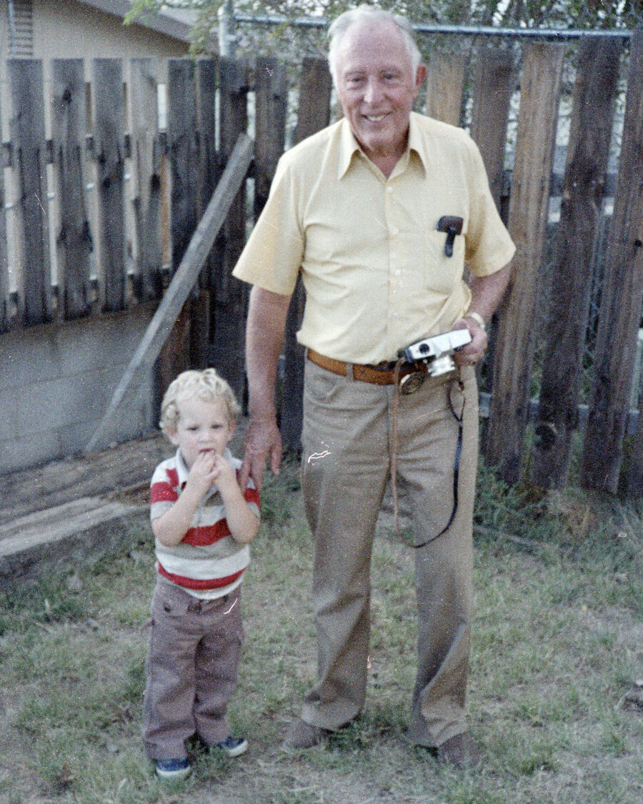 My grandfather outdoors with a camera in hand